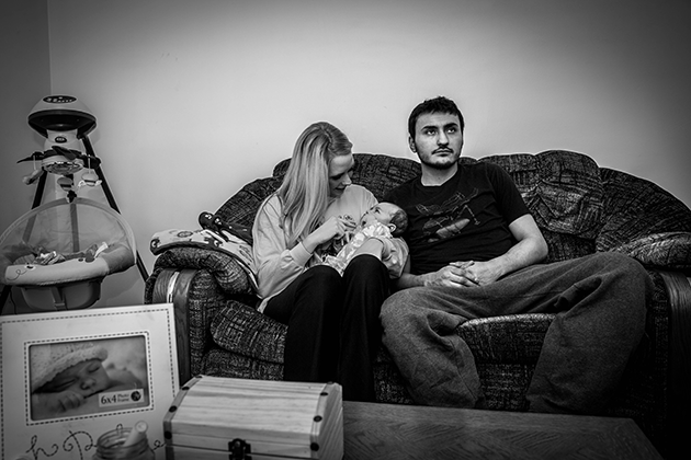 Jonathan Chavez, Kayla Jacquart, and Jameson in their apartment in Fremont, Nebraska © Mary Anne Andrei