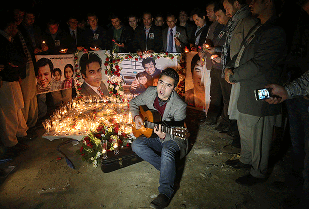 Colleagues and friends gather to remember Afghan journalist Sardar Ahmad during a memorial in Kabul, Afghanistan, Wednesday, March 26, 2014. © AP Photo/Massoud Hossaini