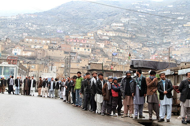 Afghan men line up outside a polling station to cast their ballots in Kabul, Afghanistan, Saturday, April 5, 2014. © AP Photo/Rahmatullah Nikzad