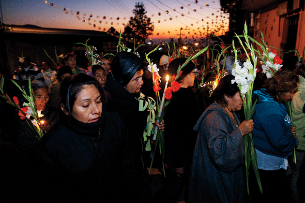 Villagers carry flowers in a parade on the morning of the patron saint’s birthday, Totontepec Villa de Morelos, Oaxaca