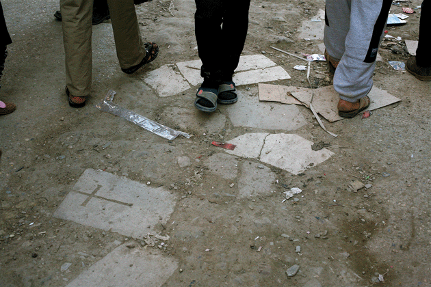 WWI-era British military gravestones fill potholes in a street in the Kut souk, 2013