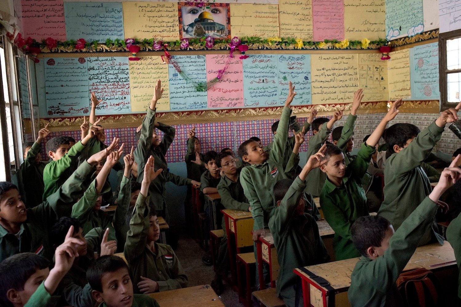 Yemeni boys raise their hands eagerly to answer a question in class. Their classroom in the Houthi-controlled area of Sa'ada is better supplied than most schools in Sana'a.