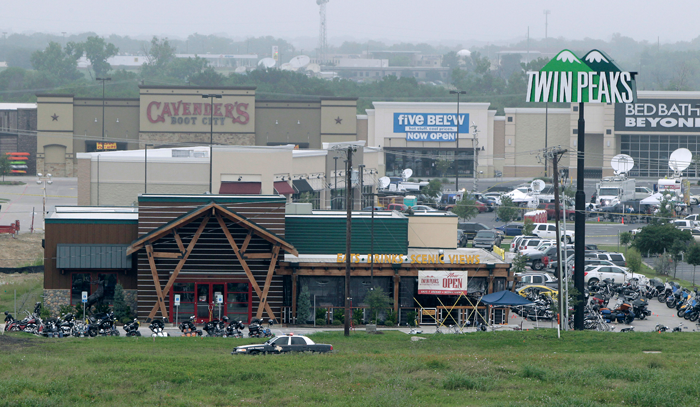 Motorcyles sit in the parking lot of the Twin Peaks restaurant, the scene of a motorcyle gang shootout, May 18, 2015 in Waco, Texas. A shootout between rival biker gangs began in the afternoon May 17, led to nine dead, many injured and 170 arrerested. (Photo by Erich Schlegel/Getty Images)