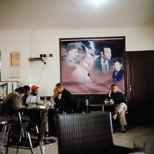 A poster of four generations of Moroccan kings on the wall of a café