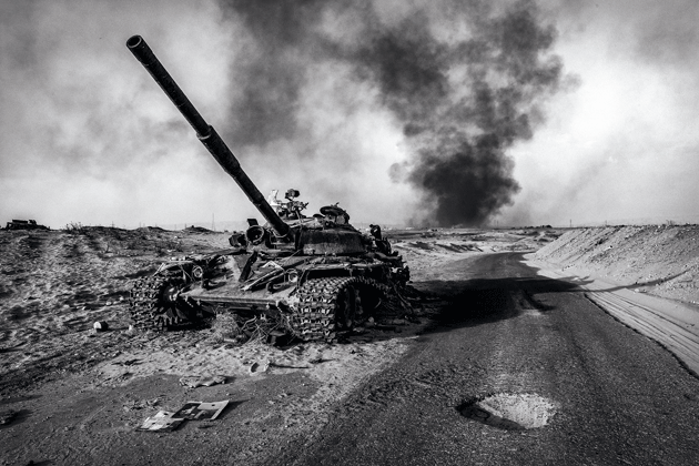A destroyed Islamic State tank near burning oil fields, Baiji, Iraq