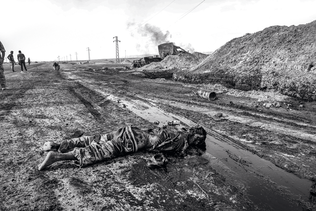 Dead Islamic State fighter in a pool of oil, Baiji
