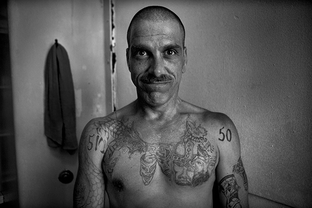 Eddie Tate showing some of his prison tattoos in the Old San Bruno County Jail, south of San Francisco, August 4, 2006.