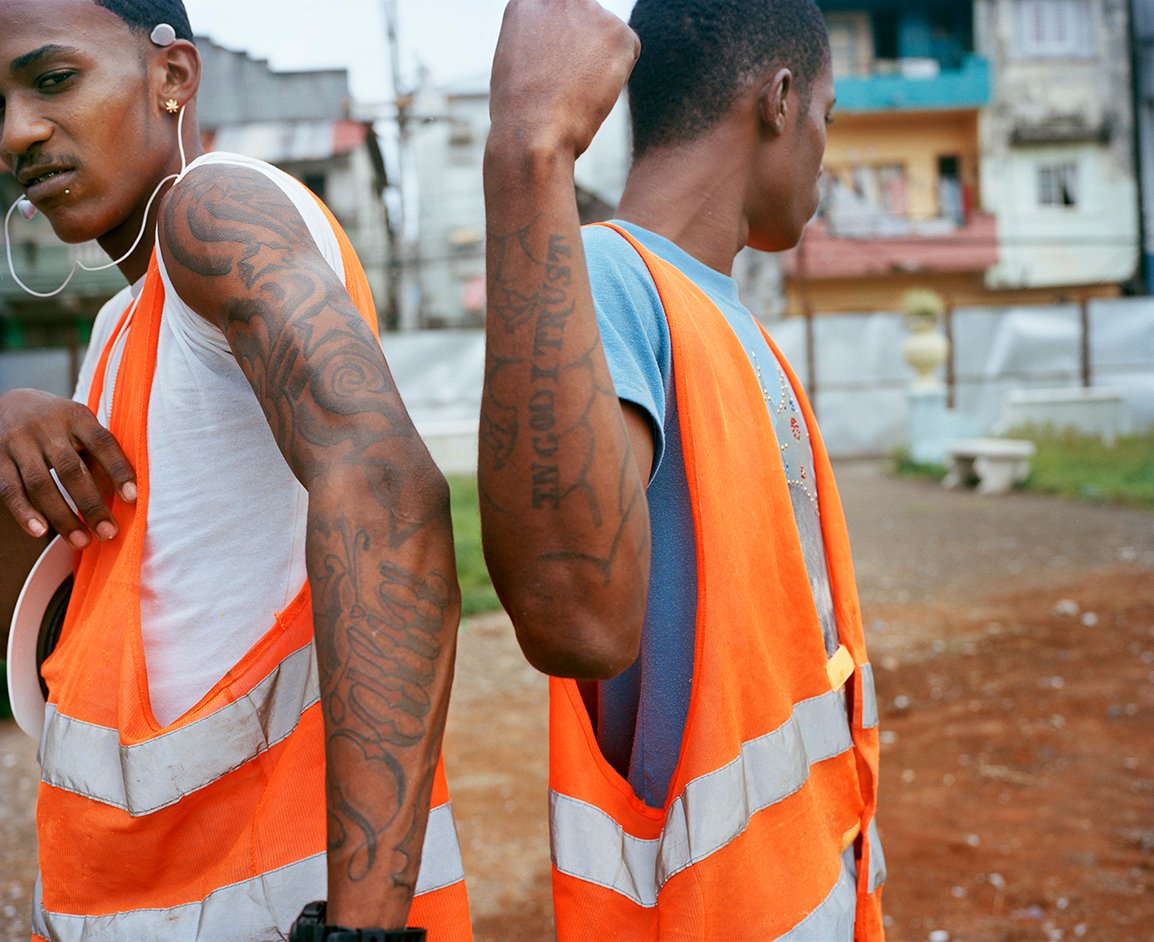 Young men on their first day working as part of Barrio Seguro. They are attempting to leave gang life behind, but their tattoos assert the difficulty of extricating themselves from this life. 