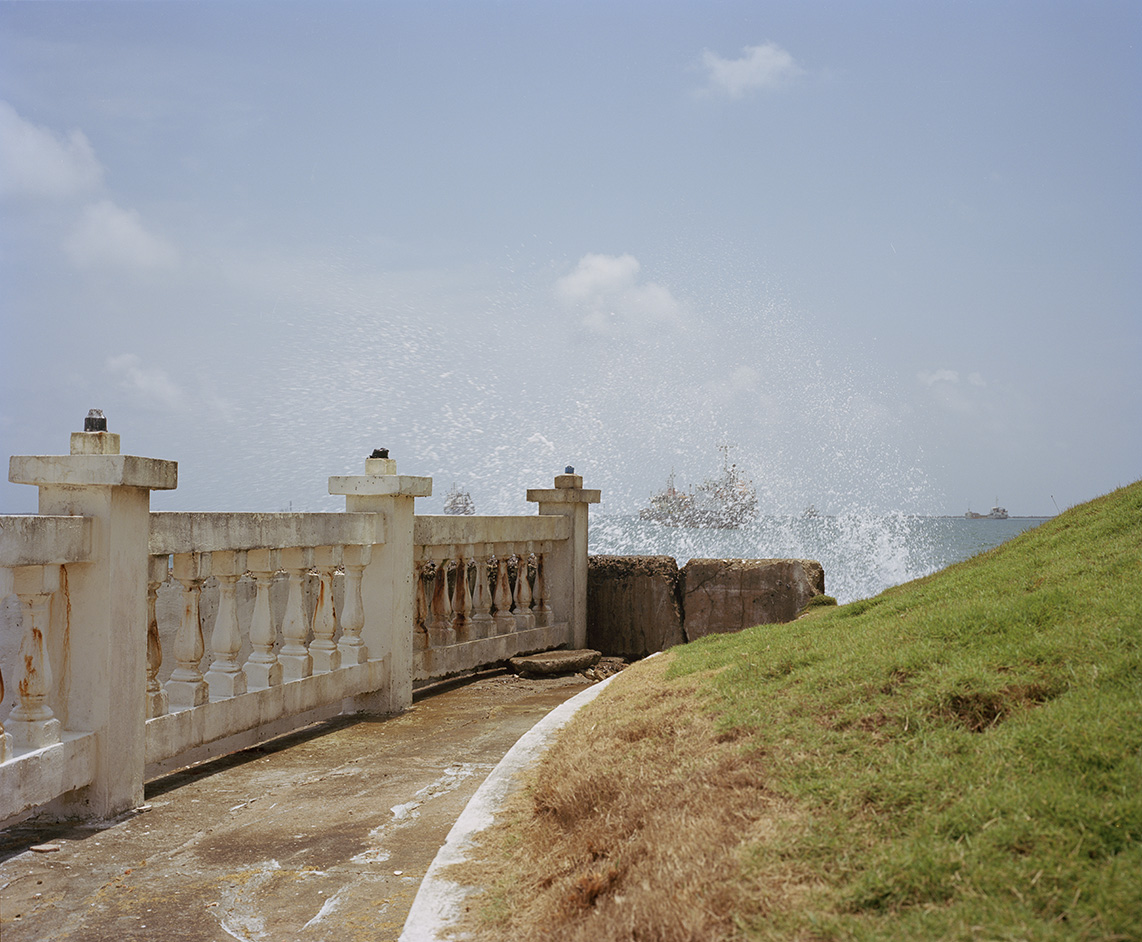 The seawall behind the Hotel Washington. In this distance, container ships line up to enter the Panama Canal.