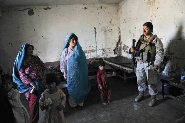 Lance Corporal Elisabeth Reyes, twenty, visits with Afghan women and their children at a clinic in Nawzad, in nothern Helmand province, May 2010 © Lynsey Addario/Getty Images Reportage