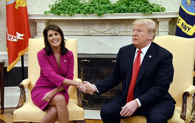 Nikki Haley shakes or holds Donald Trump’s hand