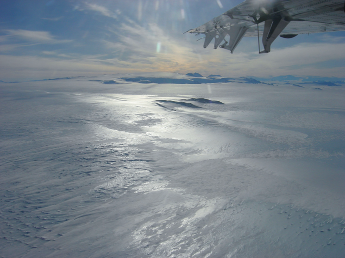 Photograph of Graves Nunataks looking northeast with the La Gorce Mountains in the background. Courtesy Antarctic Search for Meteorites (ANSMET)/John Schutt.