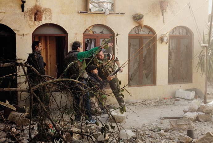 Rebel fighters prepare to launch a grenade with a homemade slingshot in the Old City, Aleppo, 2013 © Moises Saman/Magnum Photos