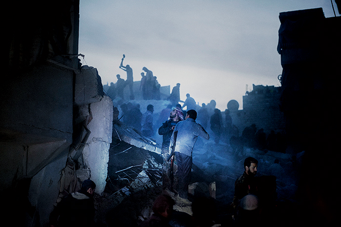 Residents and armed rebels search for survivors among the wreckage of a residential building targeted by a Syrian Air Force strike in the al-Sukri neighborhood of Aleppo, March 25, 2013 (detail) © Moises Saman/Magnum Photos