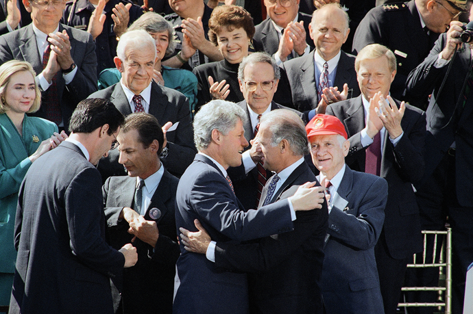 President Bill Clinton hugs Senator Joe Biden after signing the 1994 Violent Crime Control and Law Enforcement Act © AP Photo/Dennis Cook