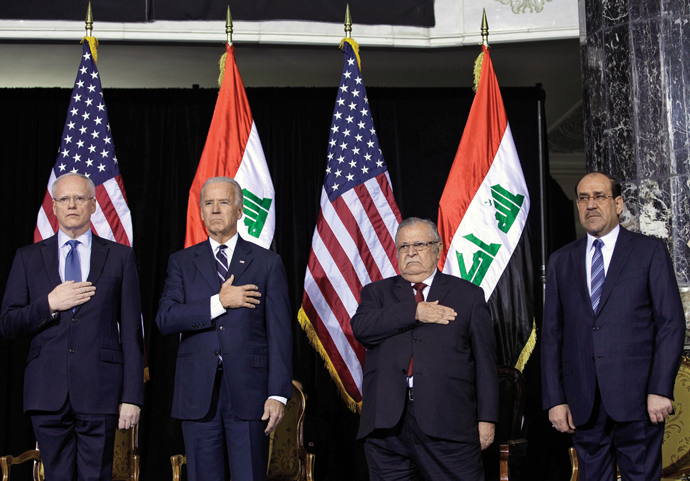 From left to right: The US ambassador to Iraq, James Jeffrey, Vice President Joe Biden, Iraqi President Jalal Talabani, and Iraqi Prime Minister Nouri al-Maliki, during the playing of the Iraqi and US national anthems at Camp Victory in Baghdad, December 2011 © AP Photo/Khalid Mohammed
