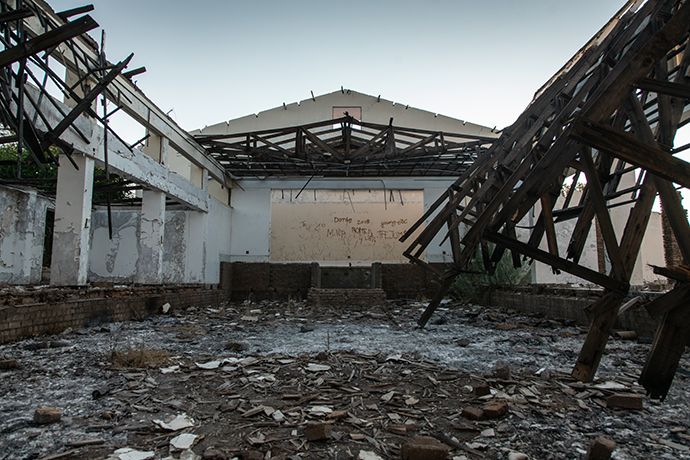 A former community hall near the center of Pomfret lies in ruins, pulled down by police officers during attempts to relocate residents and shut down the town in 2008. The town’s clinic, post office, and police station, among other public buildings, are similarly derelict. 