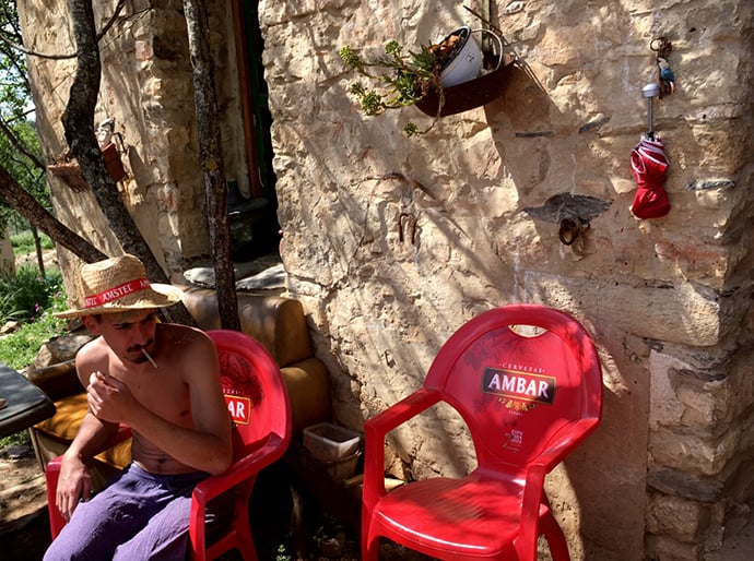 Fraguas volunteer Jose Vi takes a break from construction work to smoke outside the Casa Cándida.