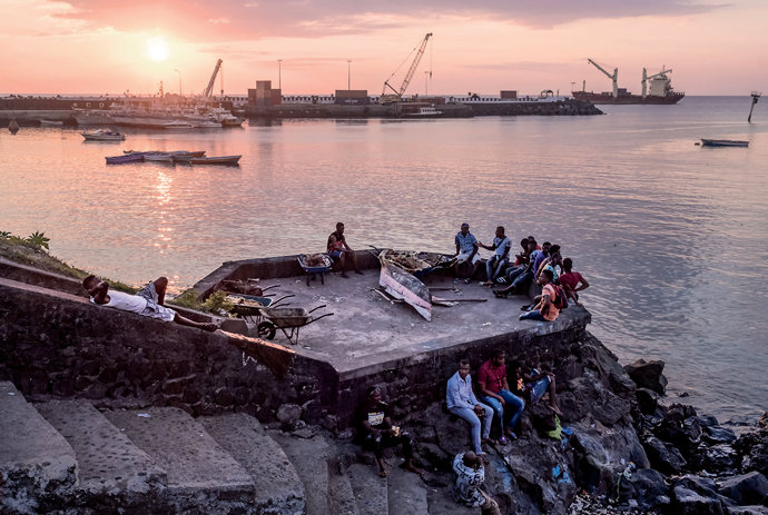 Comorians resting on the waterfront in Moroni, the capital of the Union of the Comoros. All photographs from the Comoro Islands, August 2019, by Tommy Trenchard for Harper’s Magazine © The artist