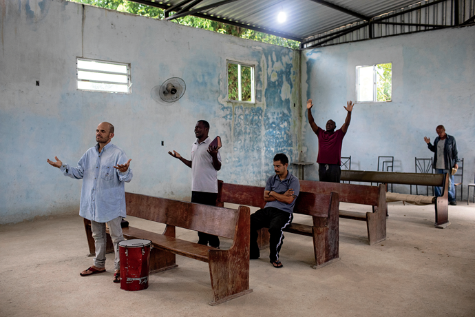 Patients at the Assembly of God True Grapevine’s drug-rehabilitation center during a morning devotional sermon