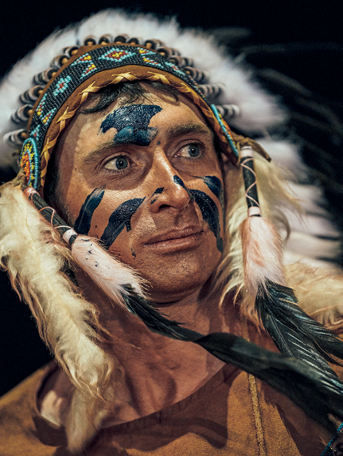 Dan Henry Hanson in the role of the Indian Chief during a performance of The Legend of Rawhide. Opposite page: A scene from the play. All photographs from Lusk, Wyoming, July 2019, by Balazs Gardi for Harper’s Magazine © The artist