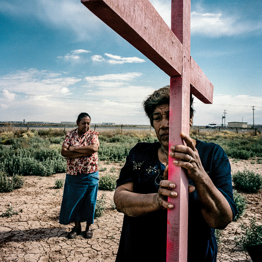 Family members of femicide victims place a memorial in a field outside Ciudad Juárez in 2006. The bodies of eight murdered women were discovered there in 2001. © Maya Goded