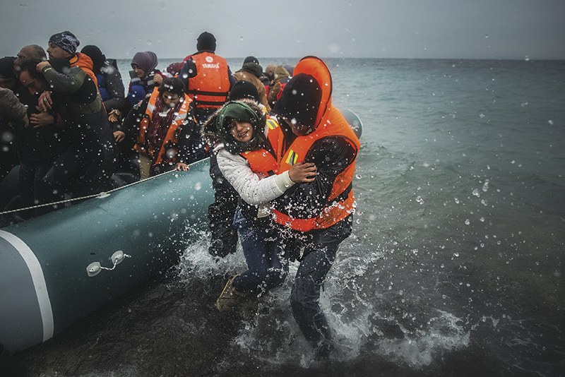 Migrants land on the island of Lesbos, Greece, after crossing from Turkey, 2016 © AP Photo/Santi Palacios
