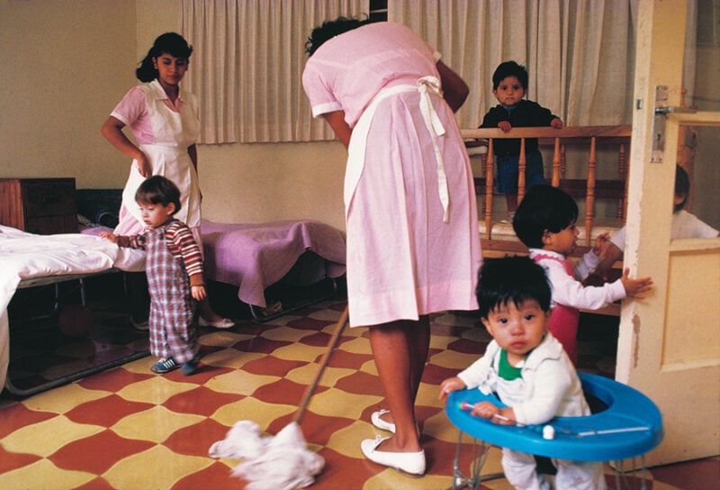 Childcare workers with children waiting for adoption, Guatemala, 1989