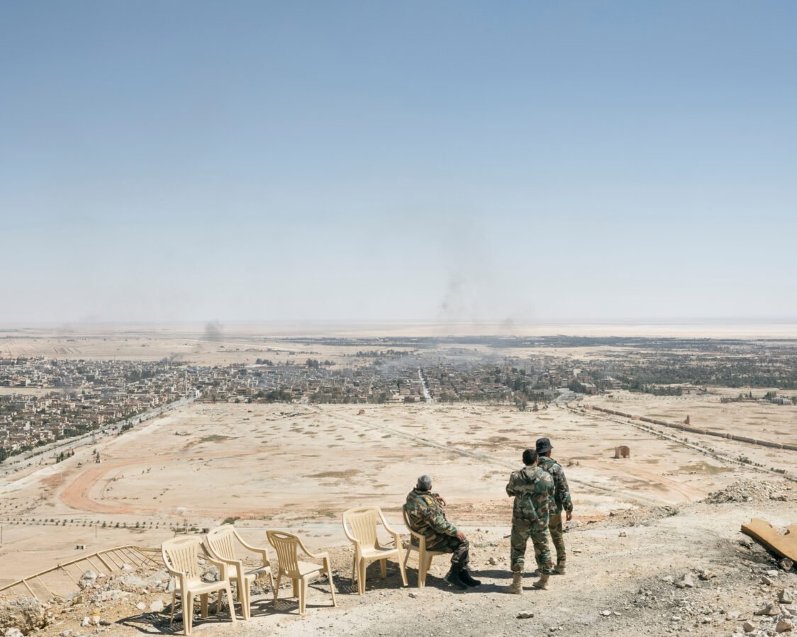 A Syrian general and two soldiers gaze across the city of Palmyra from a medieval citadel, April 2016 (detail)© Lorenzo Meloni/Magnum Photos. Meloni’s book We Don’t Say Goodbye was published by GOST Books.